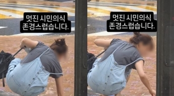 쪼그려 앉아 맨손으로 침수 도로 하수구 치운 시민…