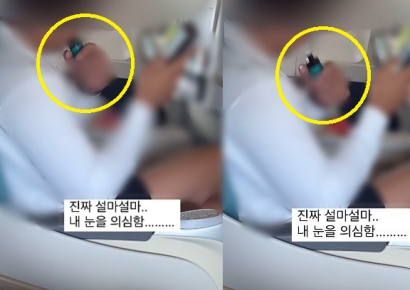아이도 있는 비행기 안에서…휴대폰 보며 전자담배 '뻑뻑'